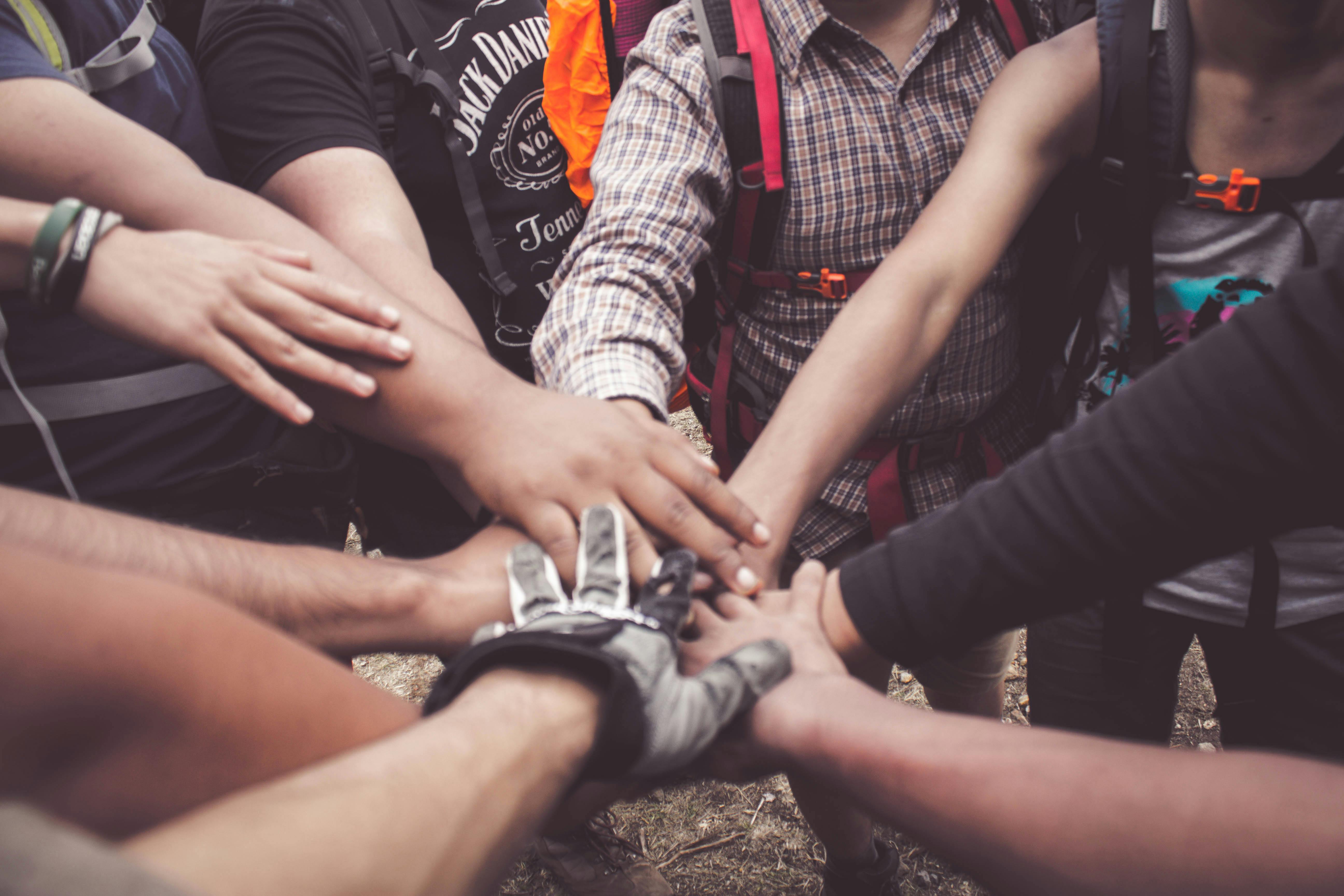 Team joining hands together in unity